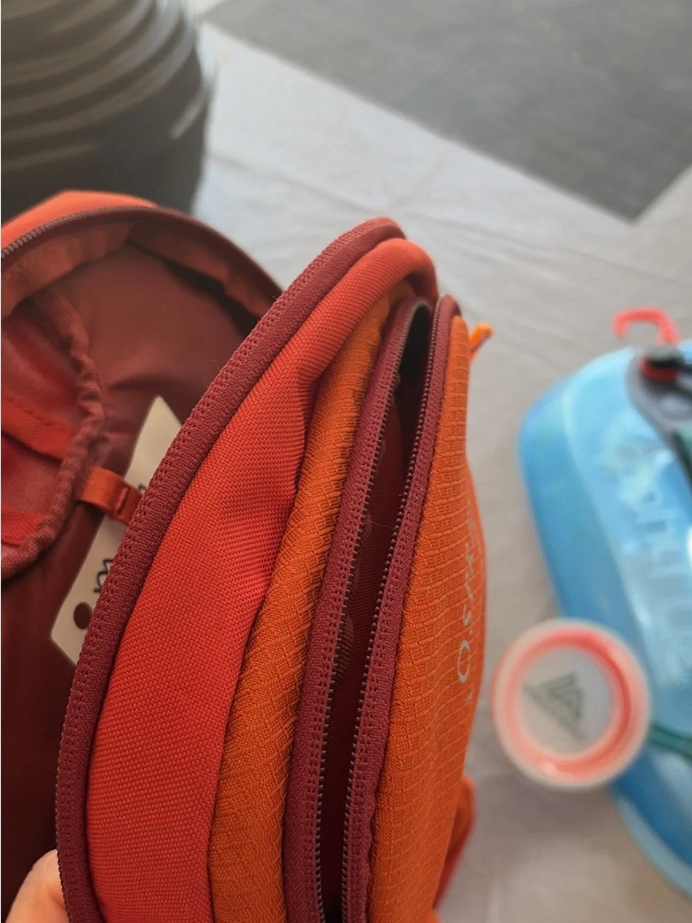 OSPREY Kids Daylite Jr Daypack in Bright Orange with Blue Hydration Reservoir